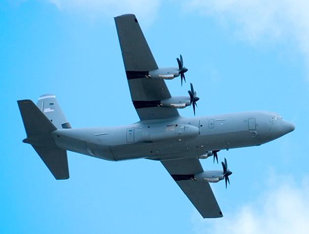 Bottom-view of a military plane in-flight against a blue sky