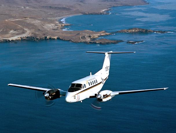 Private VIP jet flying above a coastline